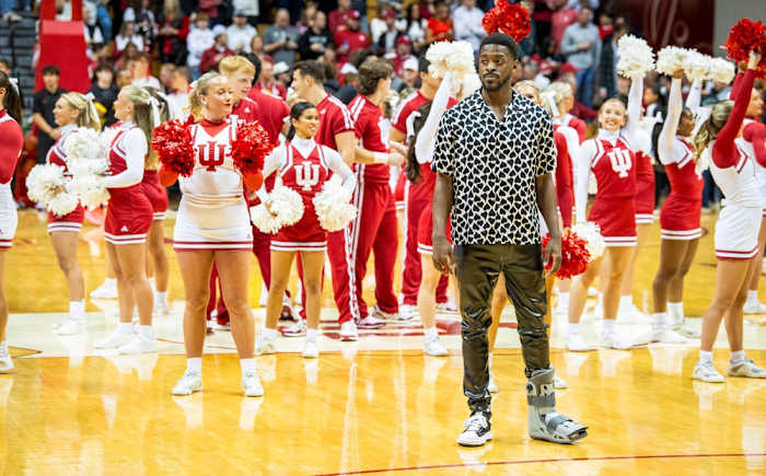 Indiana University's Xavier Johnson stands in street clothes as the Hoosiers warm-up before the start of the Indiana versus Maryland men's basketball game at Simon Skjodt Assembly Hall on Friday, Dec. 1, 2023.